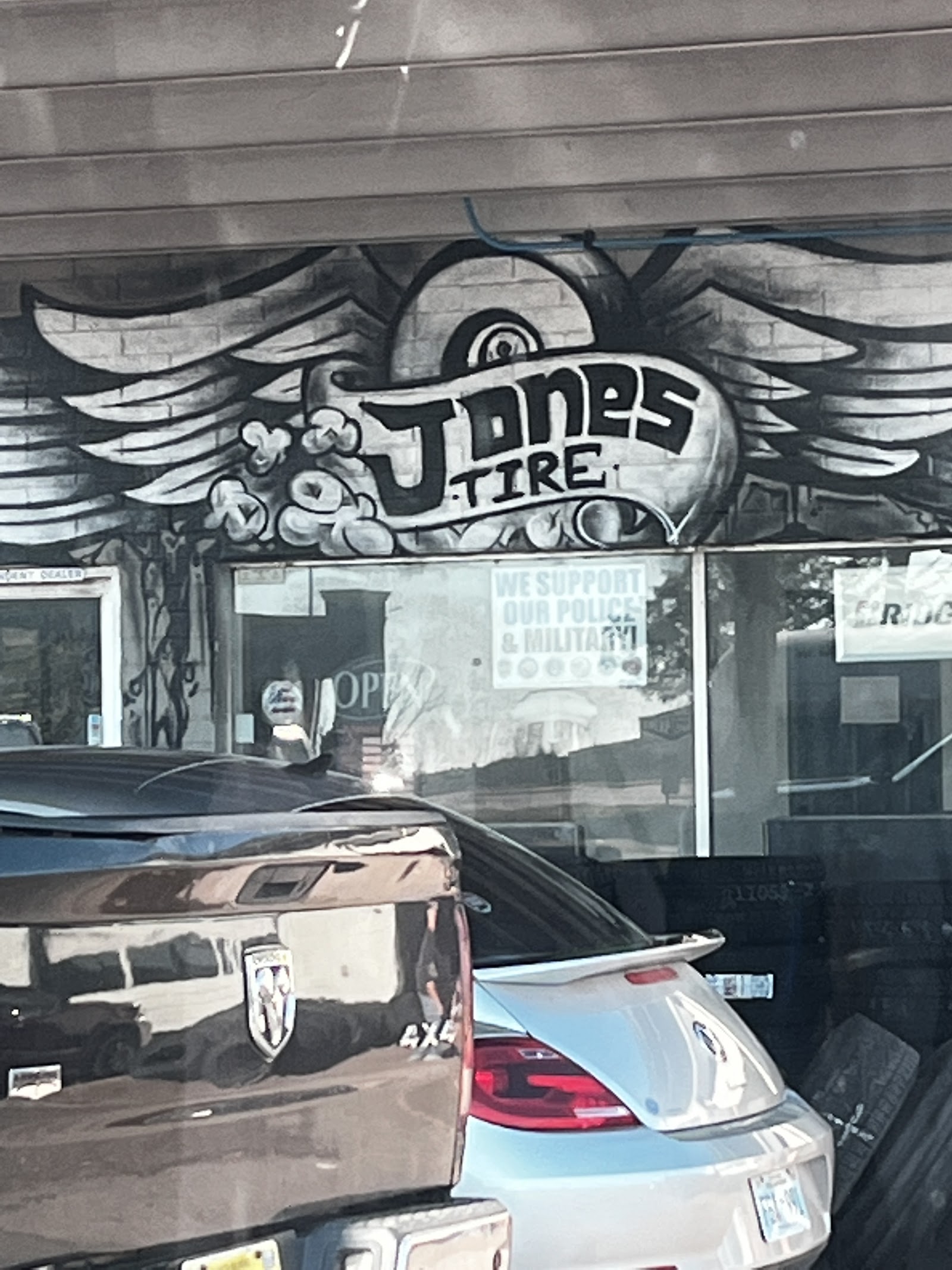 Hand-painted Jones Tire winged wheel mural on the shop wall in Moore, Oklahoma
