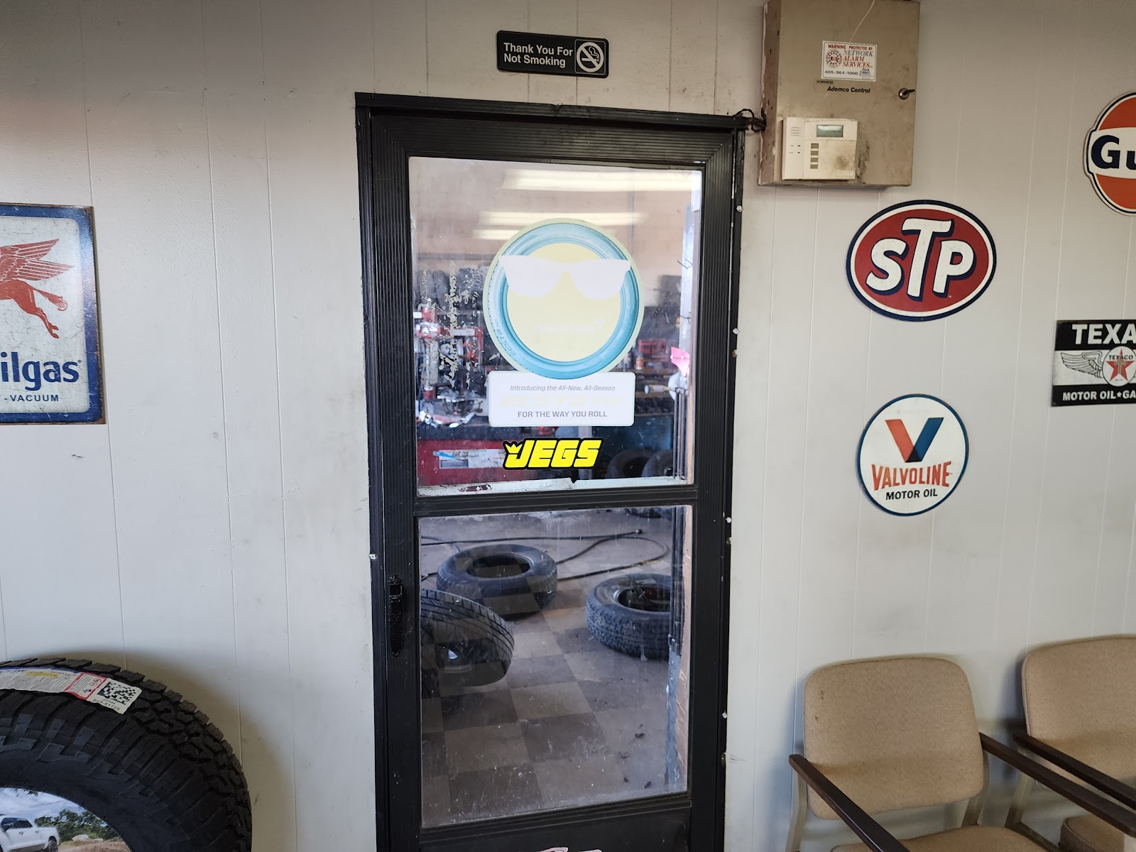 Shop door with vintage STP, Valvoline and Texaco signs