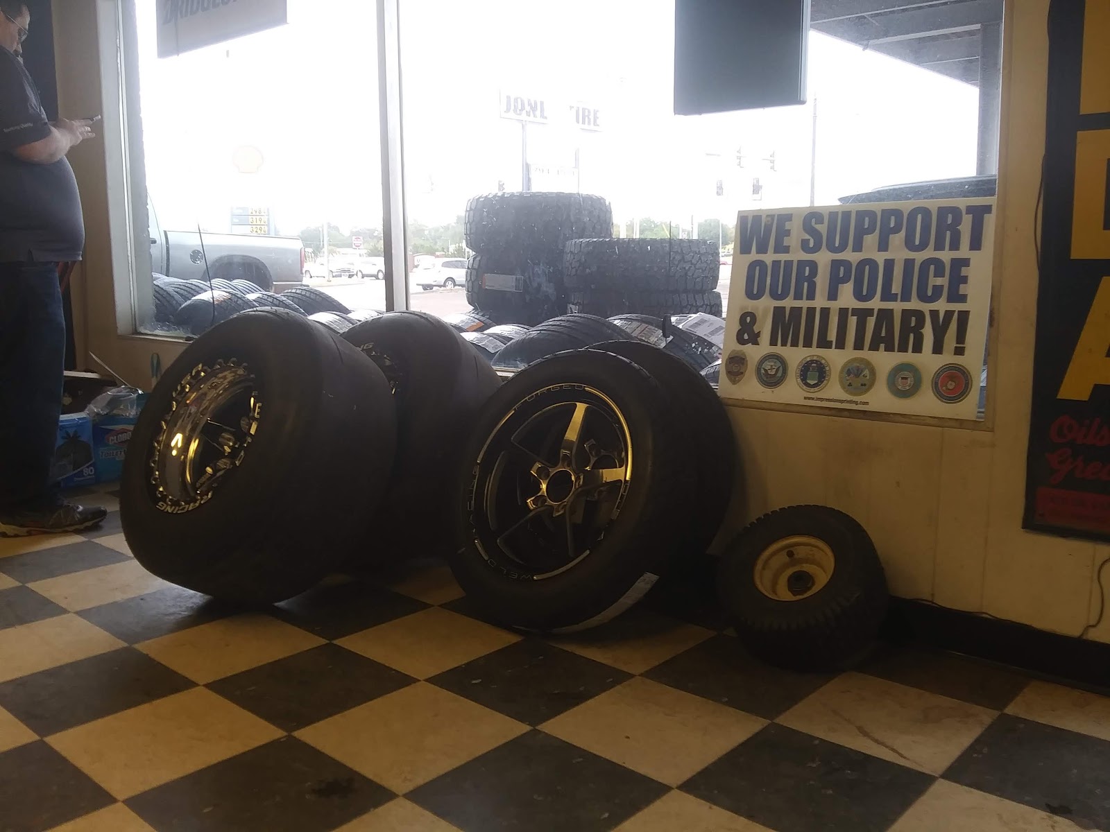 Custom gold racing wheels mounted on tires inside the shop