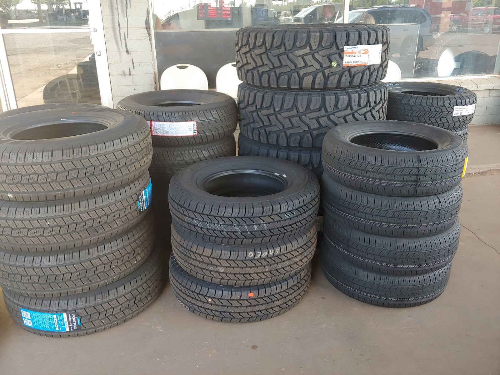 Stacks of new tires in a range of sizes outside the shop